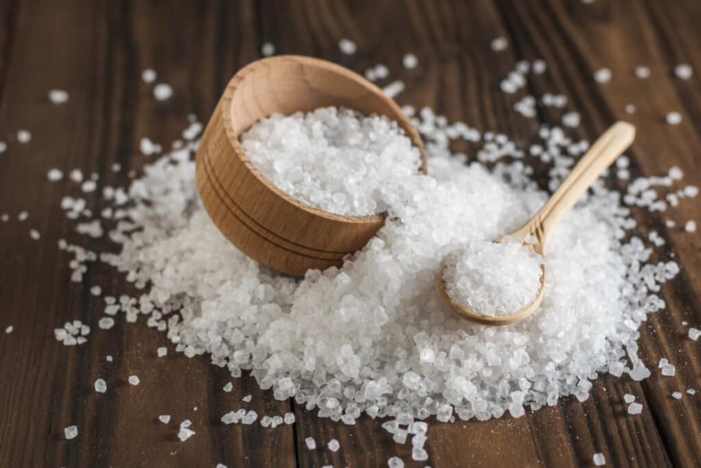 Salt on a table with spoon and bowl