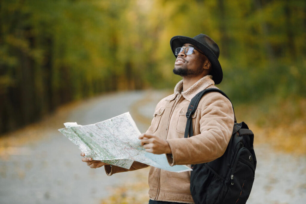 Navigating Like a Pro: How to Use a Compass and Map Black man reading a map