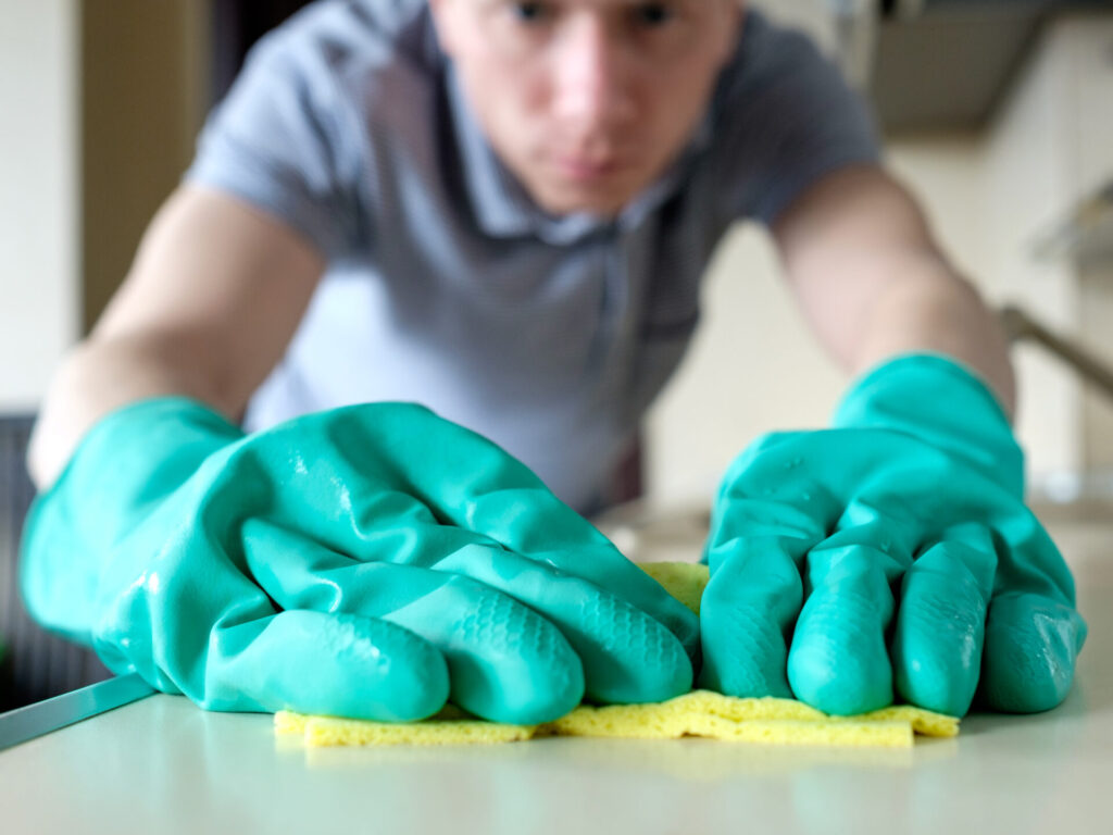 man scrubbing a table